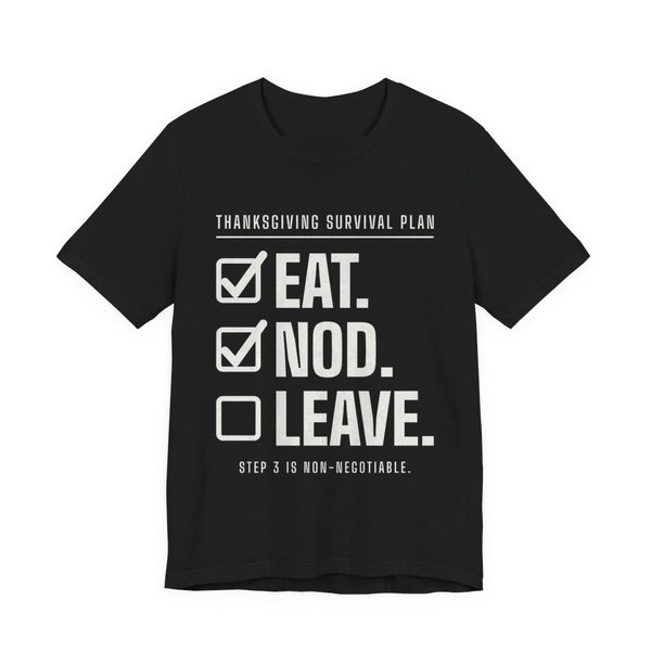 Black t-shirt printed in off-white ink with a “Thanksgiving Survival Plan” checklist: Eat. (checked), Nod. (checked), Leave. (not yet), with “Step 3 is non-negotiable”