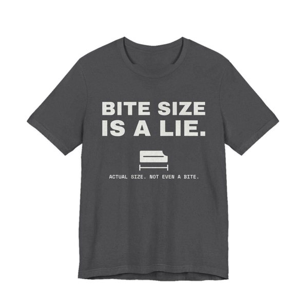 Dark Grey Heather t-shirt printed in off-white ink with “Bite Size Is a Lie.” above a tiny candy bar labeled “Actual size. Not even a bite.”