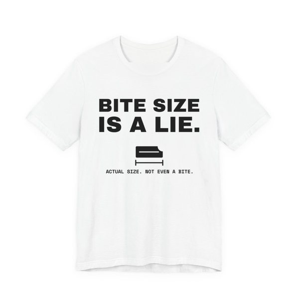 White t-shirt printed in dark ink with “Bite Size Is a Lie.” above a tiny candy bar labeled “Actual size. Not even a bite.”