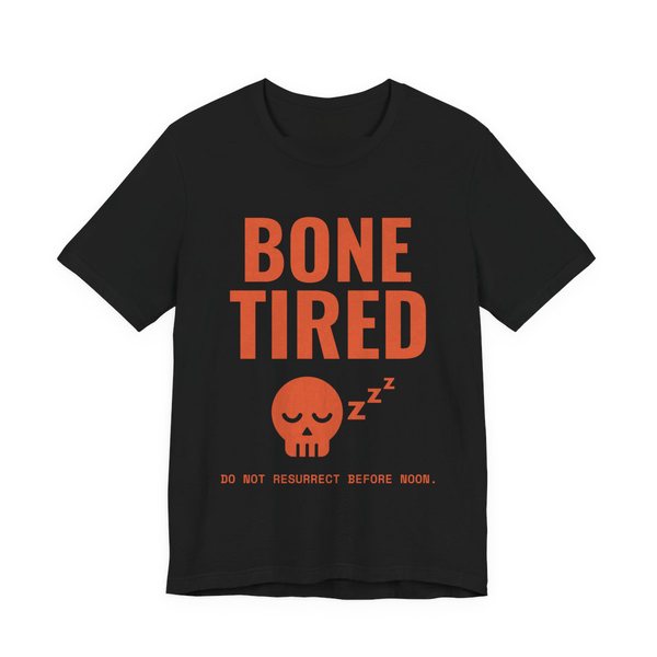 Black t-shirt printed in orange ink with “Bone Tired” above a sleeping skull with little z's, and “Do not resurrect before noon.”