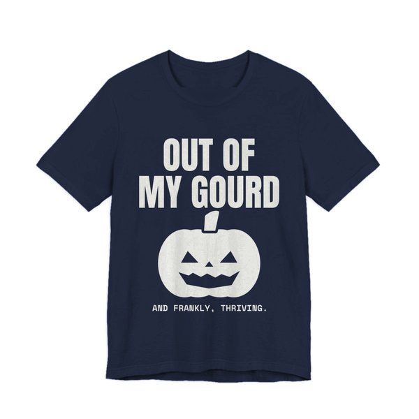Navy t-shirt printed in off-white ink with “Out of My Gourd” above a grinning jack-o'-lantern, with “And frankly, thriving.”