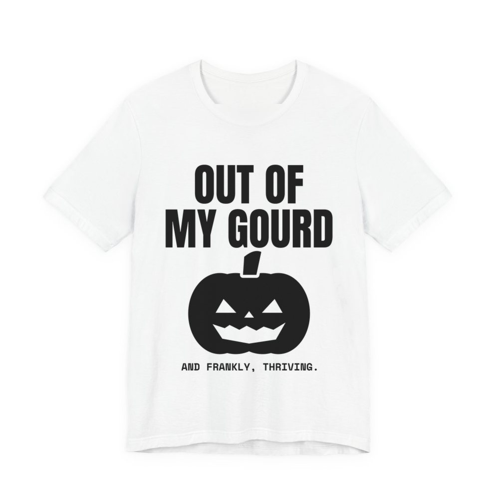 White t-shirt printed in dark ink with “Out of My Gourd” above a grinning jack-o'-lantern, with “And frankly, thriving.”