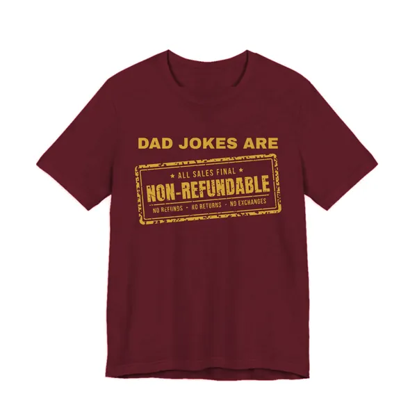 Dad Jokes Are Non-Refundable tee printed in gold ink on a maroon shirt