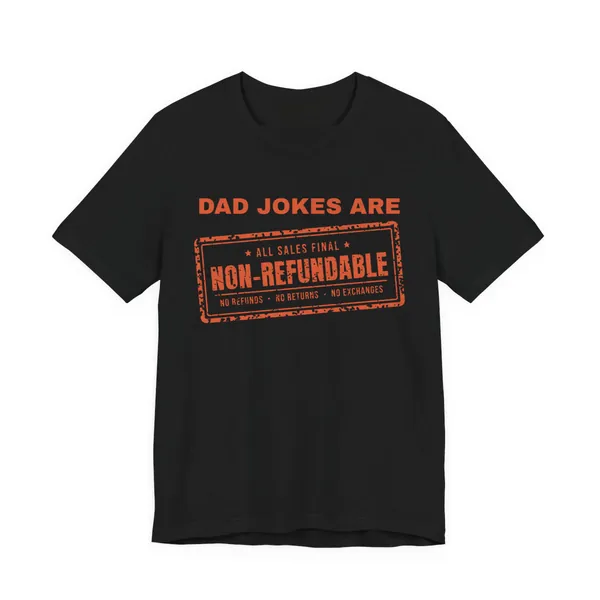 Dad Jokes Are Non-Refundable tee printed in orange ink on a black shirt