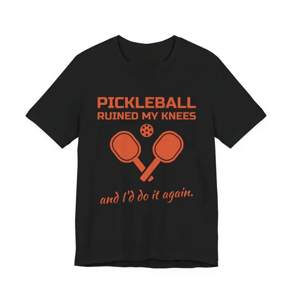 Pickleball Ruined My Knees and I'd Do It Again tee printed in orange ink on a black shirt