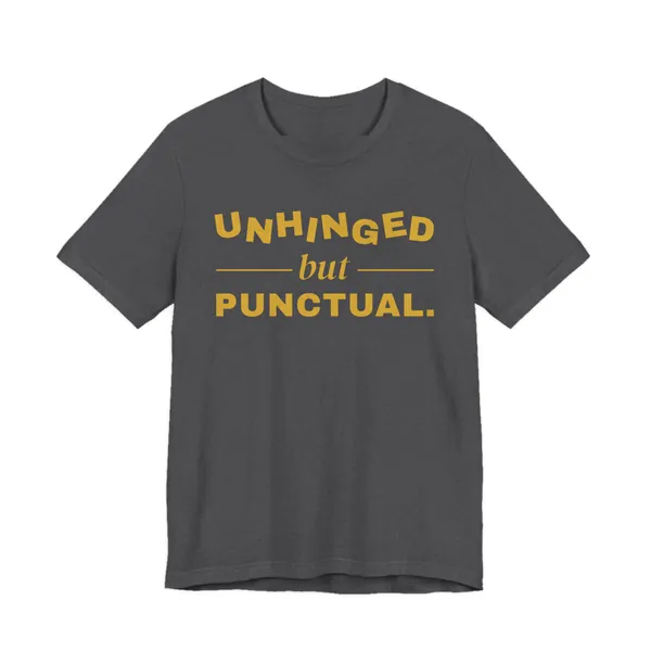 Unhinged but Punctual tee printed in gold ink on a dark grey heather shirt
