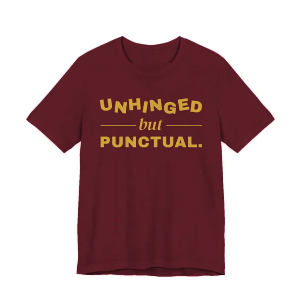 Unhinged but Punctual tee printed in gold ink on a maroon shirt