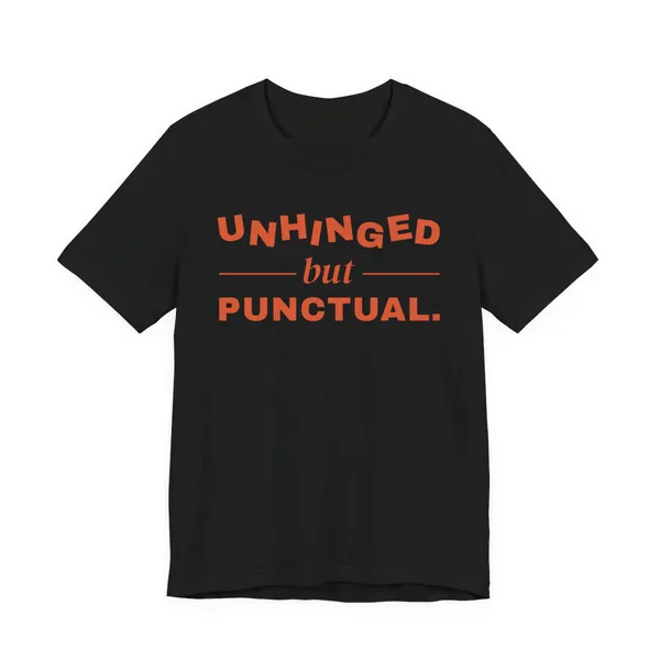 Unhinged but Punctual tee printed in orange ink on a black shirt