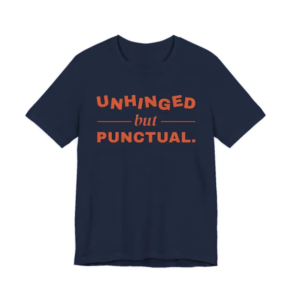 Unhinged but Punctual tee printed in orange ink on a navy shirt