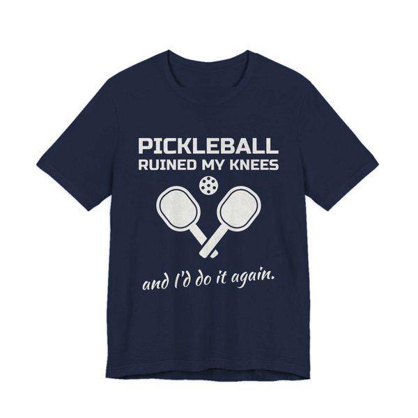Navy t-shirt printed in off-white ink with “Pickleball Ruined My Knees” above two crossed paddles and a ball, signed off with “and I'd do it again.”