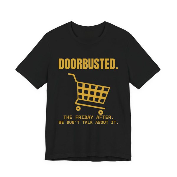 Black t-shirt printed in gold ink with the word “Doorbusted.”