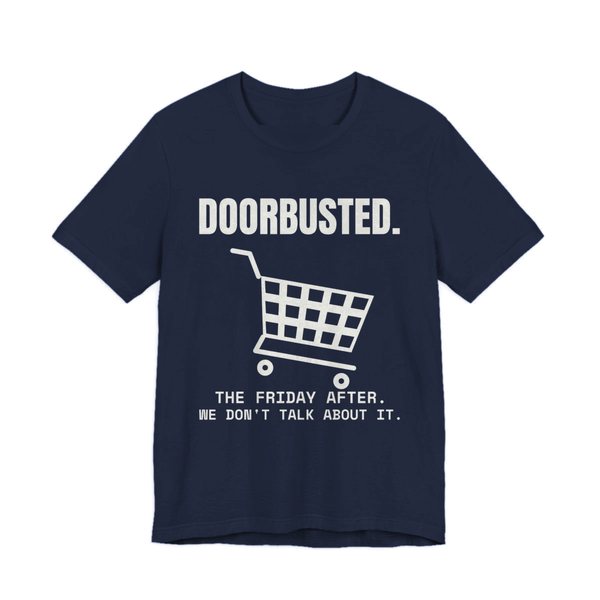 Navy t-shirt printed in off-white ink with the word “Doorbusted.”