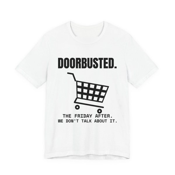 White t-shirt printed in dark ink with the word “Doorbusted.”