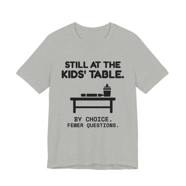 Athletic Heather t-shirt printed in dark ink with the words “Still at the Kids' Table.”
